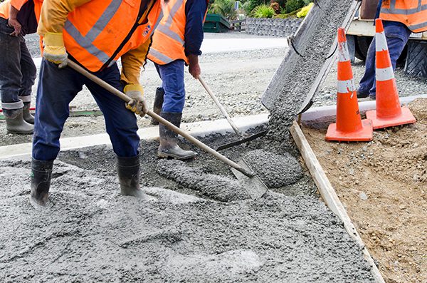 Concrete being poured onto a road.